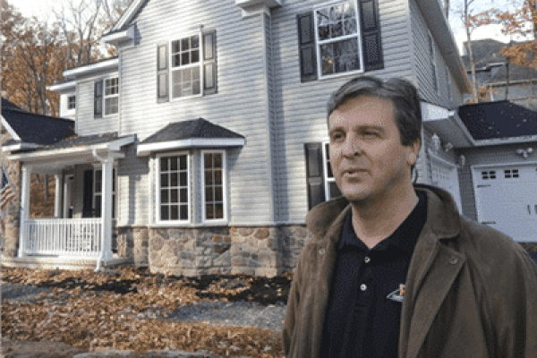 Bob standing in front of award-winning home